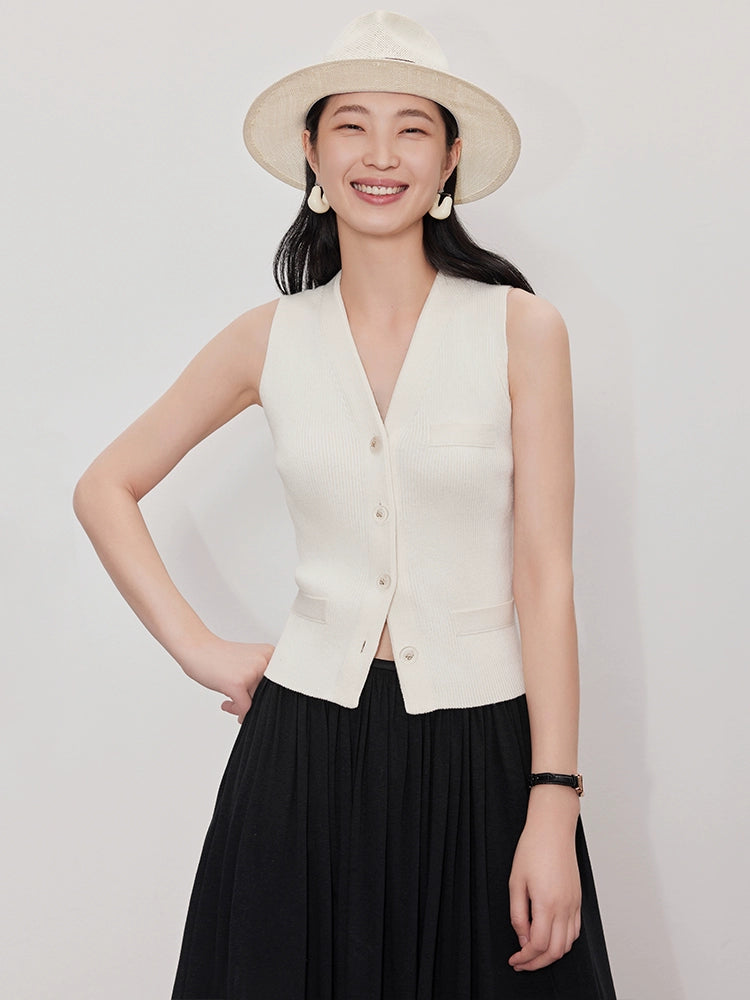 A short knit vest layered for women, a small canvas shoulder wrap with a V-neck, a very simple collared sleeveless jacket 